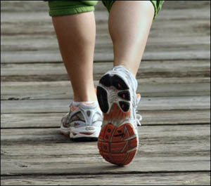 Losing weight is recommended to avoid fatty liver disease. Picture of jogger's feet.